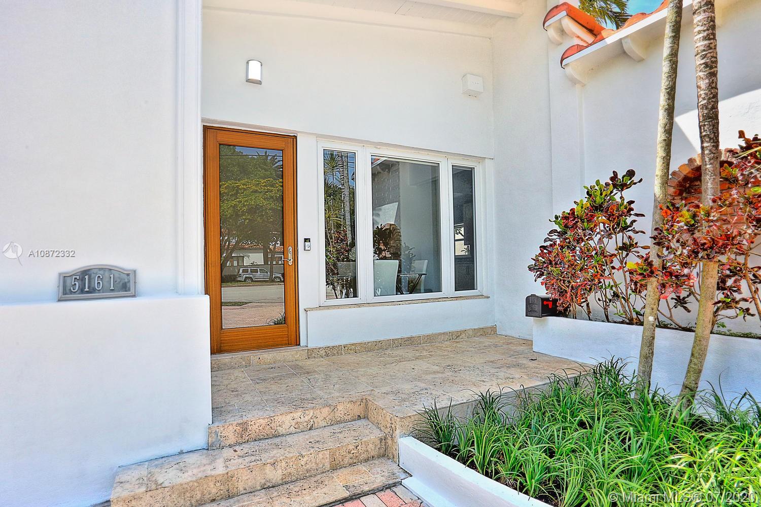5161 Alton Road Miami Beach, FL 33140 - Photo 3 of 25 front view of a house with a porch