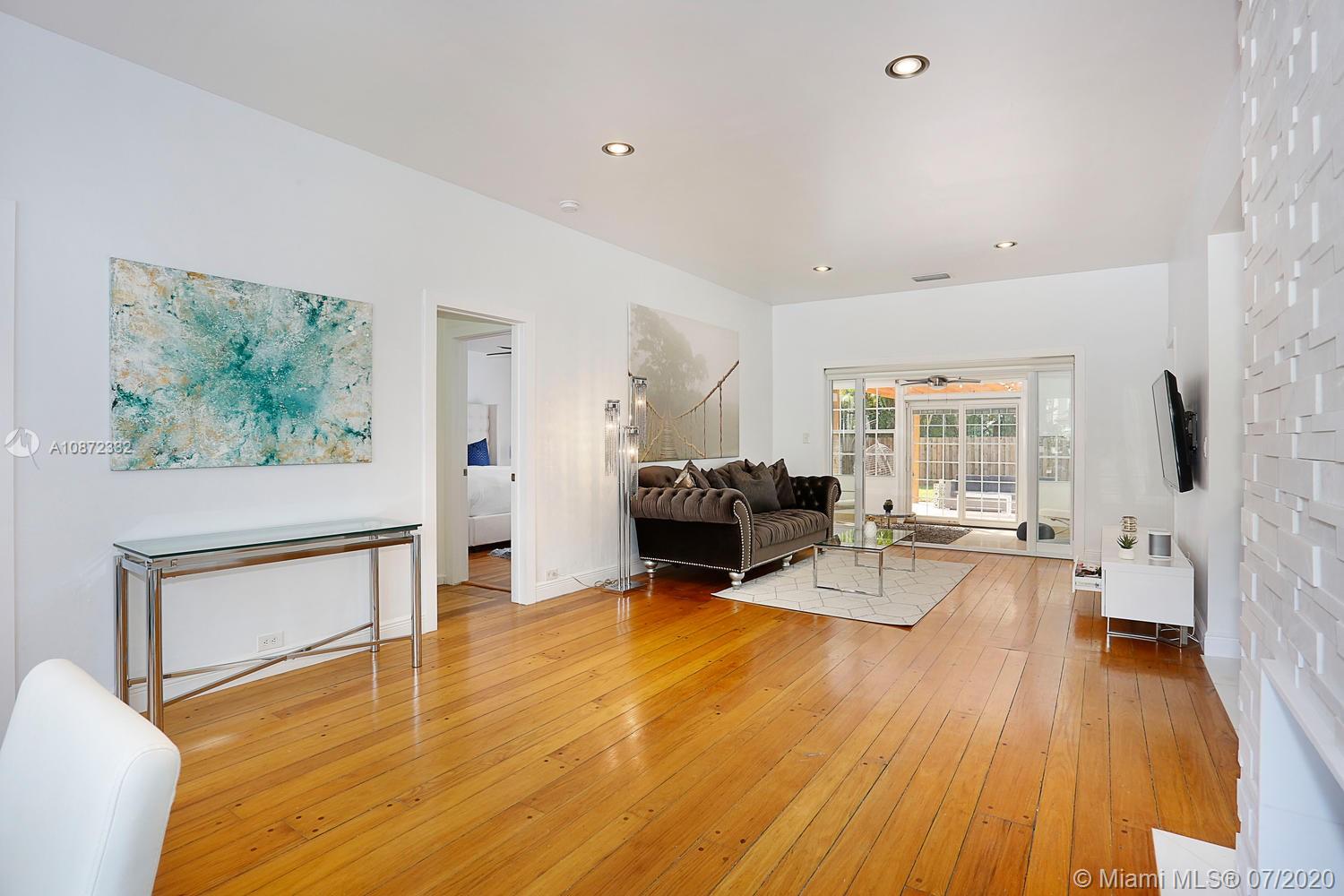 5161 Alton Road Miami Beach, FL 33140 - Photo 5 of 25 a living room with furniture and a wooden floor