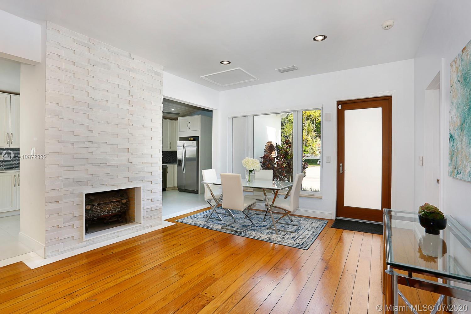 5161 Alton Road Miami Beach, FL 33140 - Photo 7 of 25 a living room with furniture and a fireplace