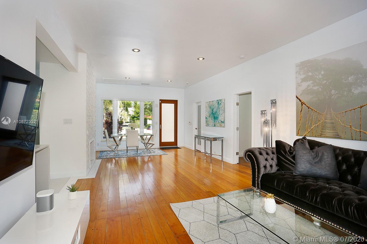 5161 Alton Road Miami Beach, FL 33140 - Photo 8 of 25 a living room with furniture and a large window