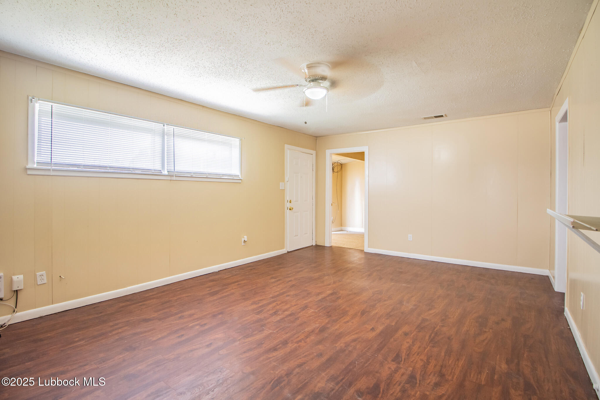 2414 38th Street Lubbock, TX 79412 - Photo 4 of 20 a view of an empty room with wooden floor