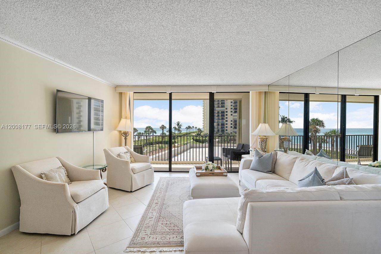 400 Ocean Trail Way, Unit 302 Jupiter, FL 33477 - Photo 12 of 29 a living room with furniture and a large window
