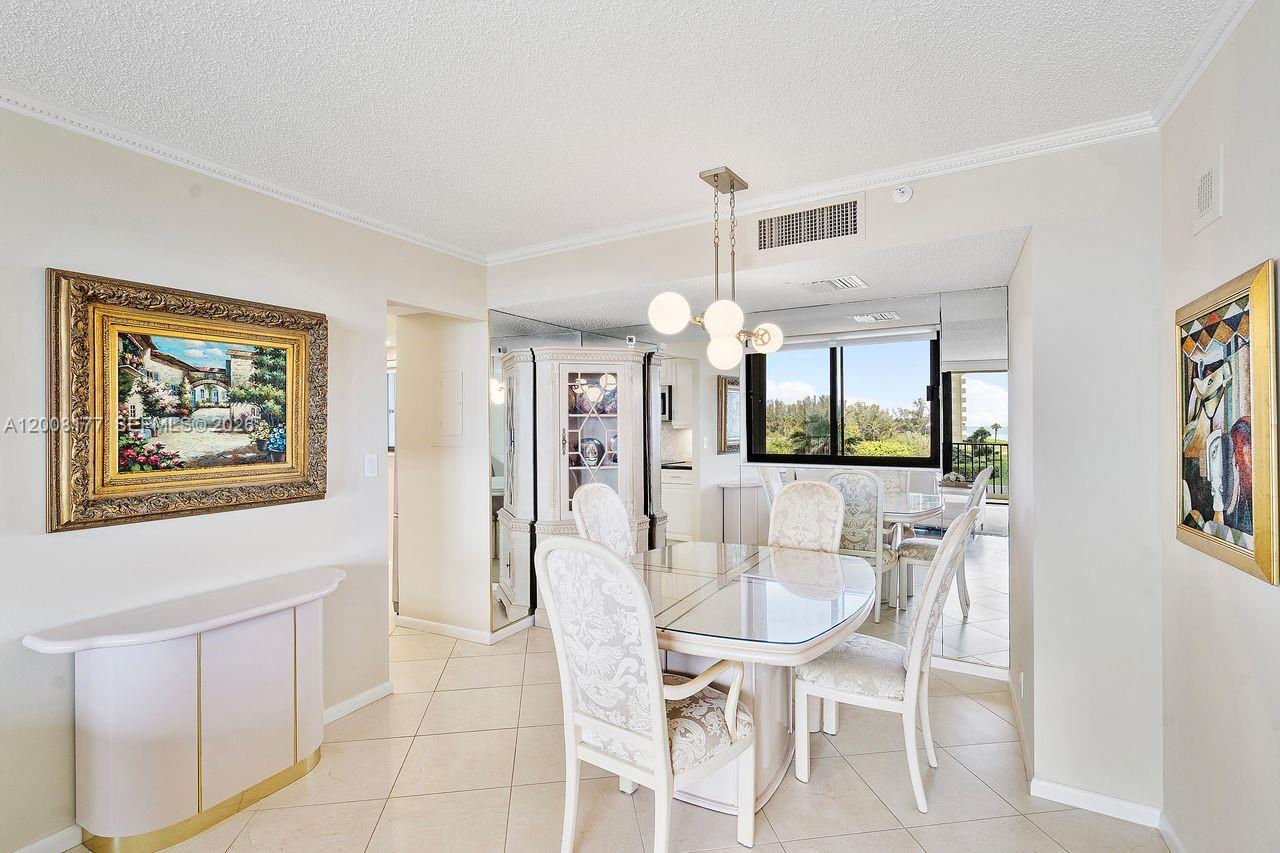 400 Ocean Trail Way, Unit 302 Jupiter, FL 33477 - Photo 15 of 29 a dining room with furniture and window