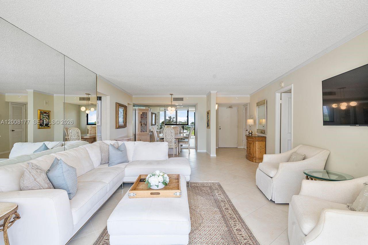 400 Ocean Trail Way, Unit 302 Jupiter, FL 33477 - Photo 17 of 29 a living room with furniture and a flat screen tv