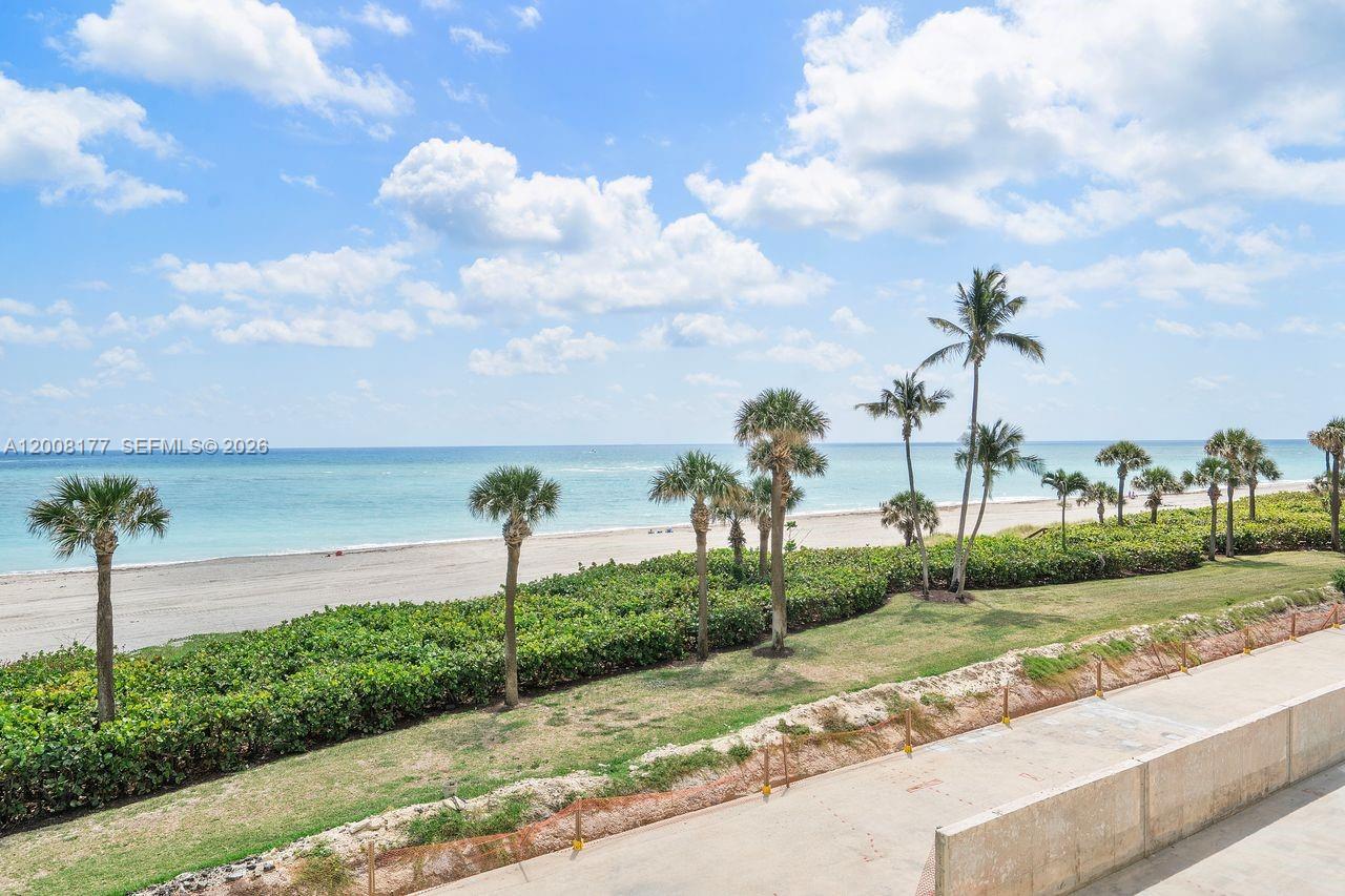 400 Ocean Trail Way, Unit 302 Jupiter, FL 33477 - Photo 25 of 29 a view of a street with a big yard and a large tree