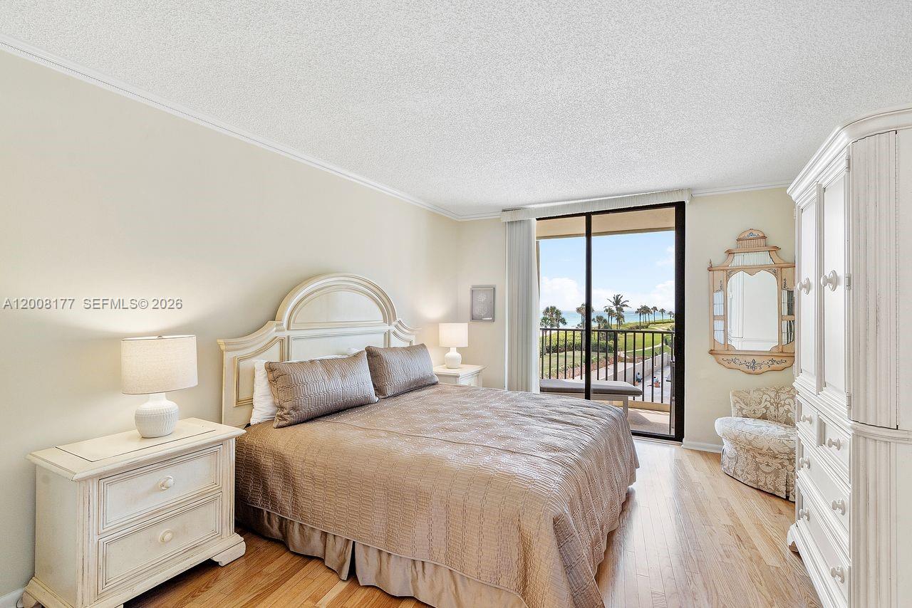 400 Ocean Trail Way, Unit 302 Jupiter, FL 33477 - Photo 7 of 29 a bedroom with a bed and a large window