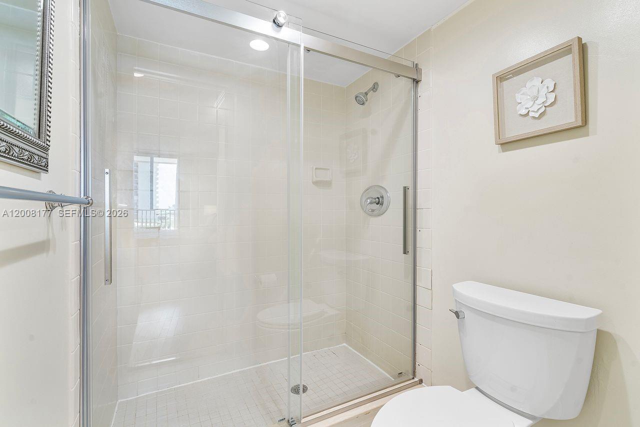 400 Ocean Trail Way, Unit 302 Jupiter, FL 33477 - Photo 10 of 29 a bathroom with a toilet and shower
