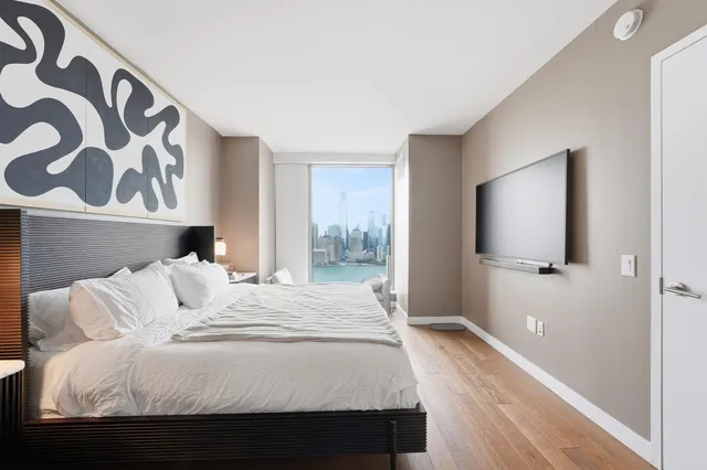 a bedroom with a large bed and a window