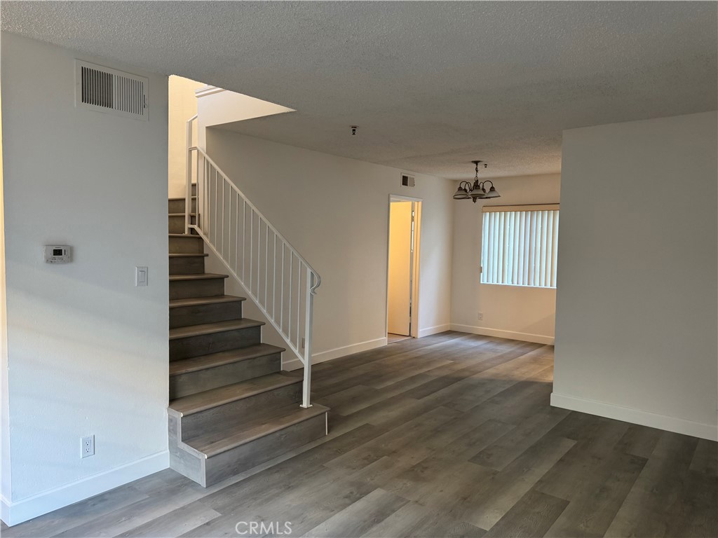 1820 Pepper Street, Unit E Alhambra, CA 91801 - Photo 13 of 30 a view of an empty room with wooden floor and stairs