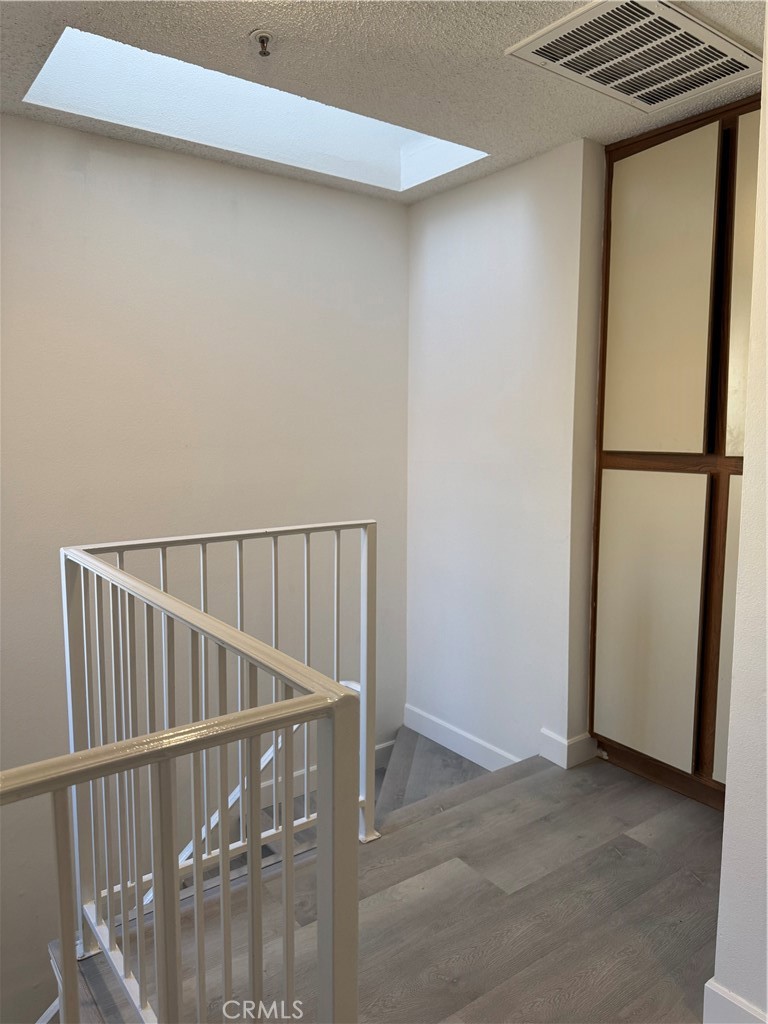 1820 Pepper Street, Unit E Alhambra, CA 91801 - Photo 16 of 30 a view of staircase with wooden floor and white walls