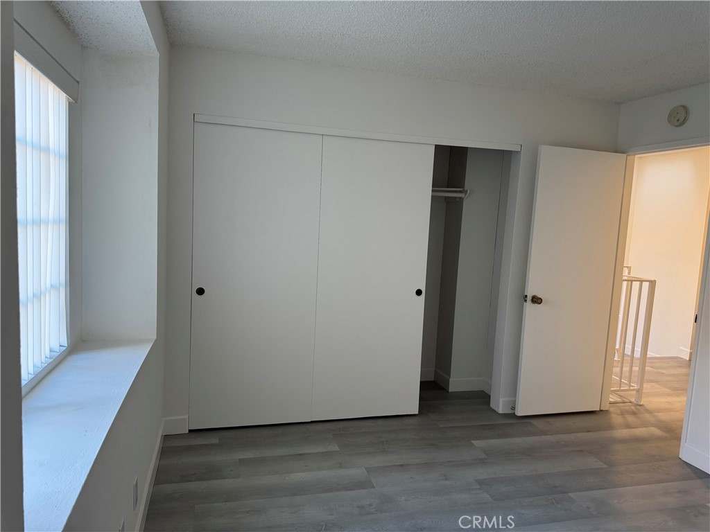 1820 Pepper Street, Unit E Alhambra, CA 91801 - Photo 19 of 30 a view of an empty room with wooden floor and a window