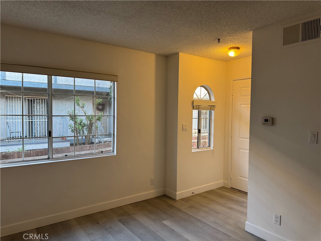 1820 Pepper Street, Unit E Alhambra, CA 91801 - Photo 6 of 30 a view of an empty room with wooden floor and a window