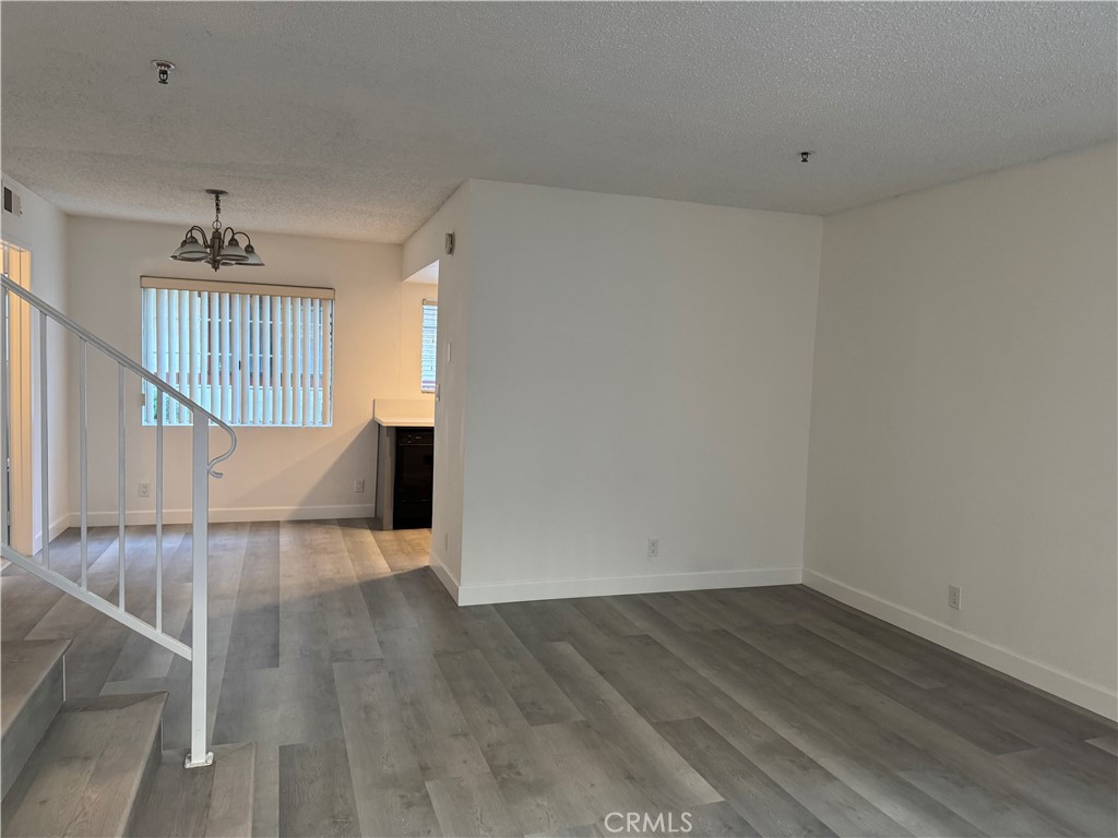 1820 Pepper Street, Unit E Alhambra, CA 91801 - Photo 8 of 30 a view of an empty room with wooden floor and a window