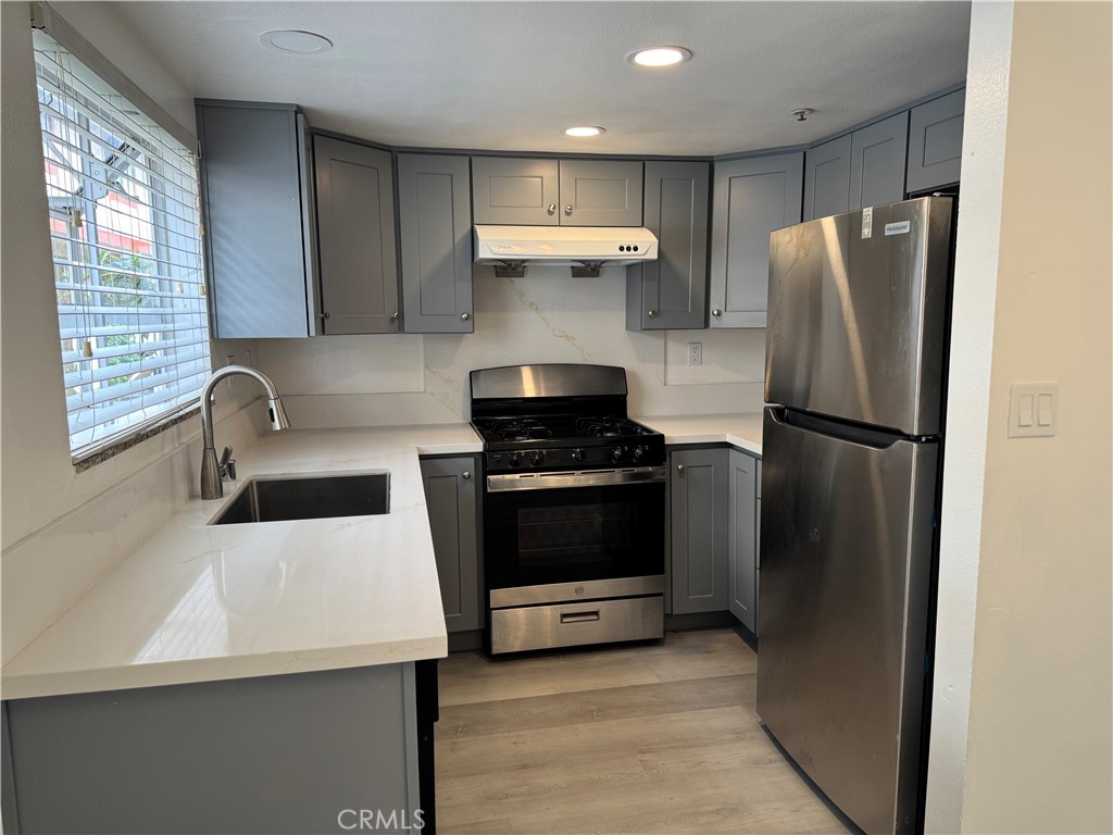 1820 Pepper Street, Unit E Alhambra, CA 91801 - Photo 10 of 30 a kitchen with a refrigerator and a sink