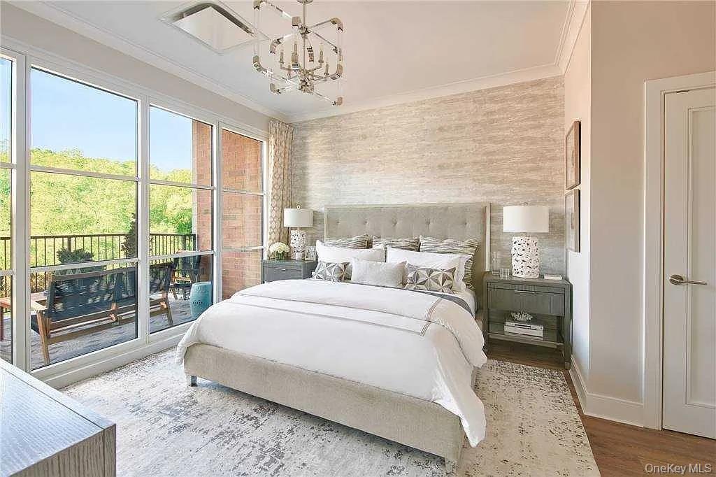 100 Garvies Point Road, Unit 1146 Glen Cove, NY 11542 - Photo 3 of 11 a bedroom with a large bed and a window