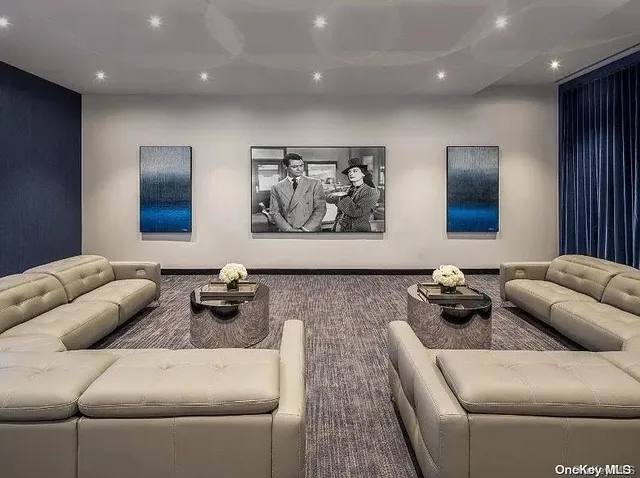 a living room with furniture and wall painting