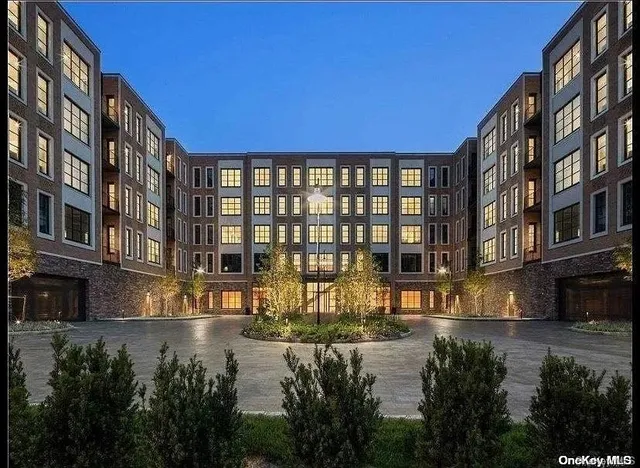 a view of a building with lake view and a street