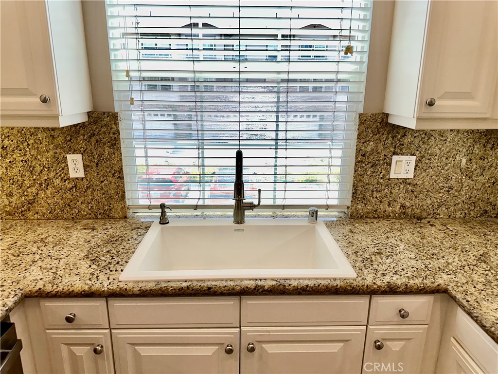 21 Durlston Way Ladera Ranch, CA 92694 - Photo 14 of 47 a bathroom with a granite countertop sink and white cabinets