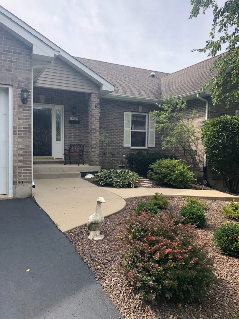 18591 Ridge Lane Marengo, IL 60152 - Photo 2 of 20 a front view of a house with yard and outdoor seating
