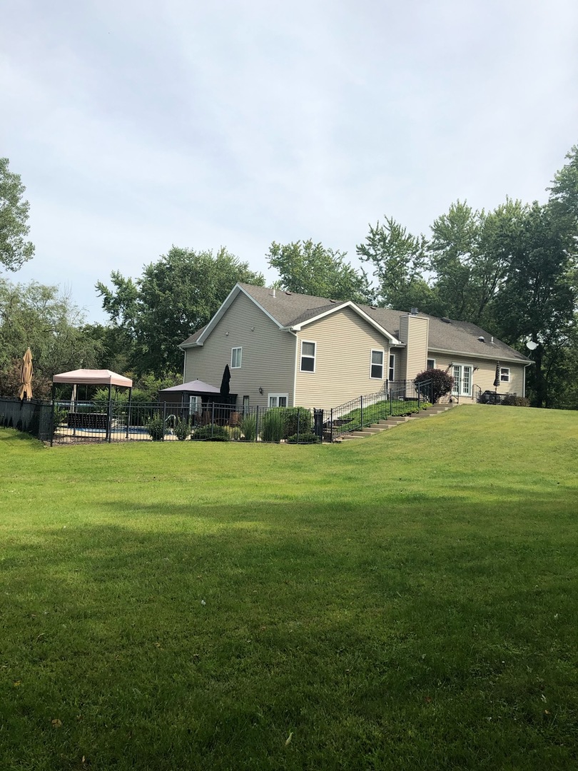 18591 Ridge Lane Marengo, IL 60152 - Photo 17 of 20 a front view of house with yard and trees around