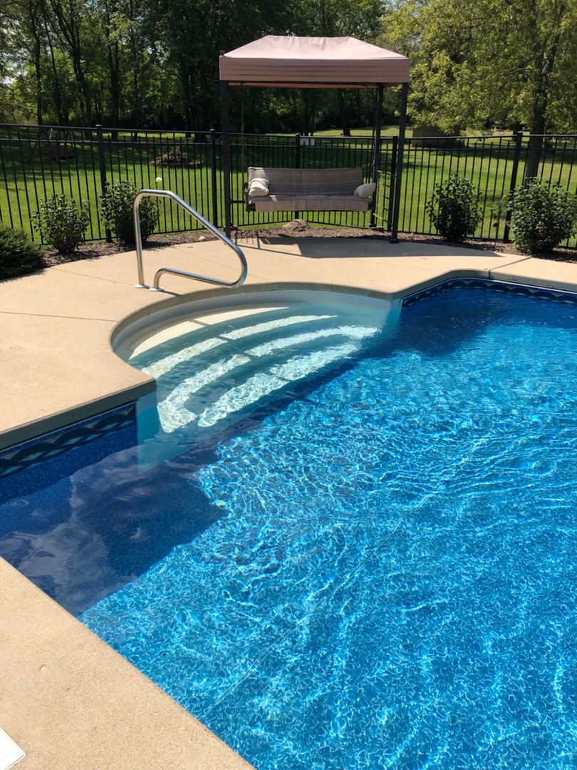 18591 Ridge Lane Marengo, IL 60152 - Photo 19 of 20 a view of a swimming pool with a patio and a garden