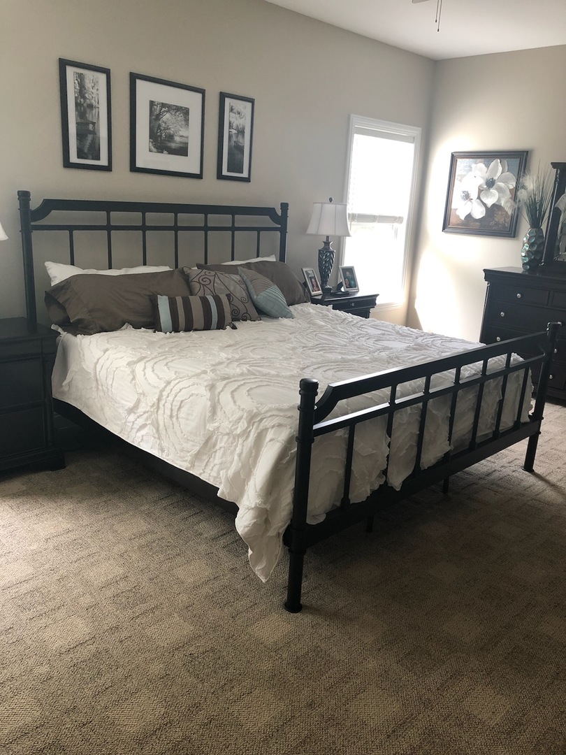 18591 Ridge Lane Marengo, IL 60152 - Photo 7 of 20 a bed sitting in a bedroom next to a window with a lamp