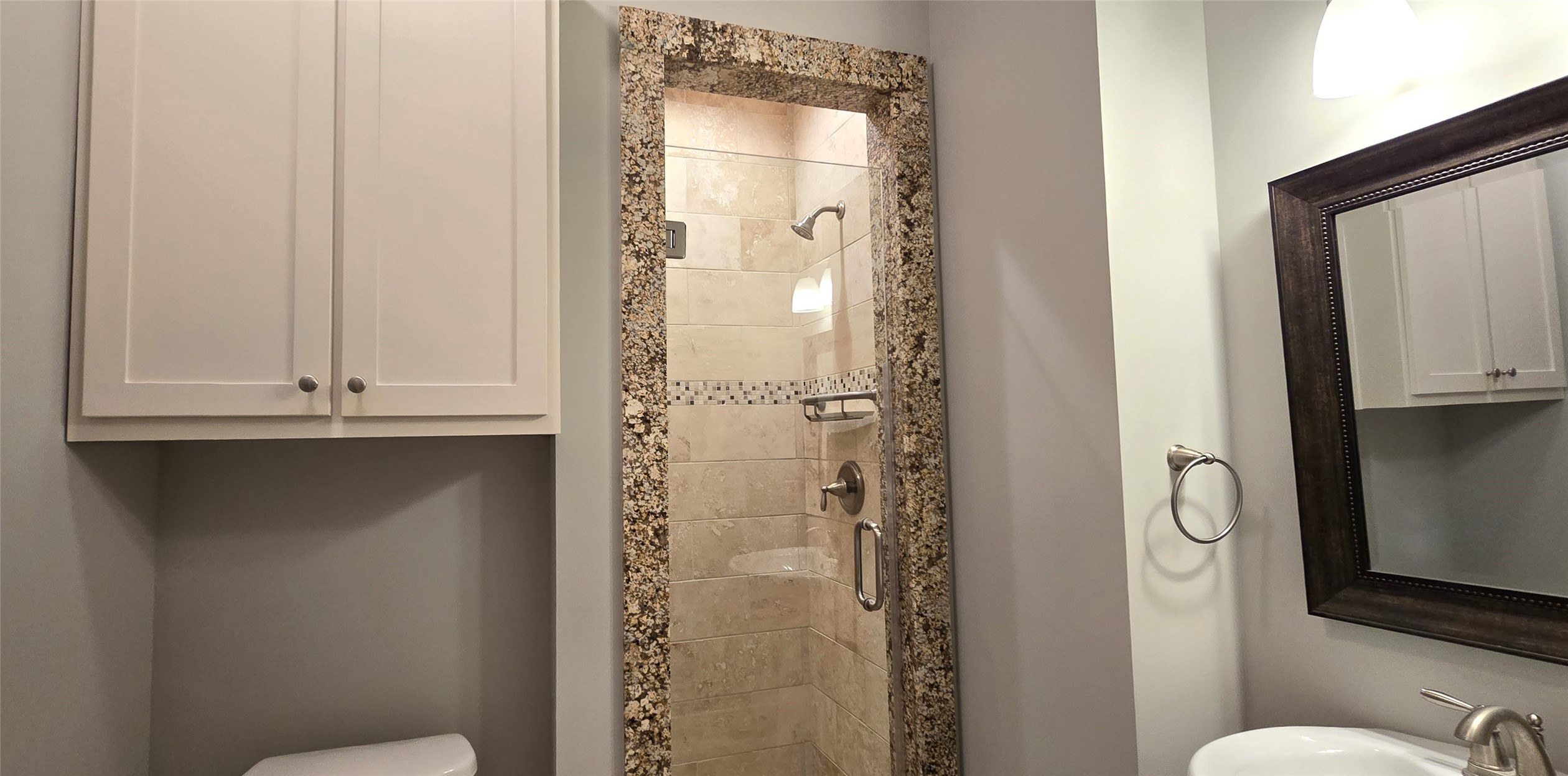 1117 Bonner Street Houston, TX 77007 - Photo 9 of 44 Bedroom 1 includes an en-suite bathroom with a tiled walk-in shower only with glass door. Also features a framed mirror, brushed nickel fixtures and built-in wall cabinets for storage.