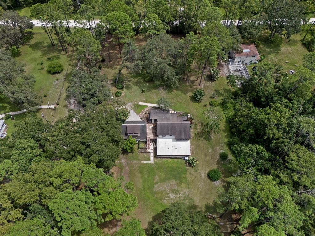 8605 Fussell Drive Wesley Chapel, FL 33545 - Photo 11 of 99 an aerial view of a house with yard swimming pool and outdoor seating