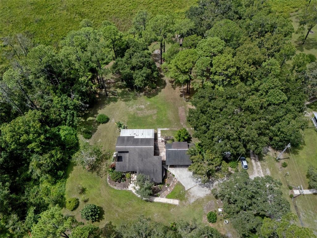8605 Fussell Drive Wesley Chapel, FL 33545 - Photo 12 of 99 an aerial view of a house with yard swimming pool and outdoor seating