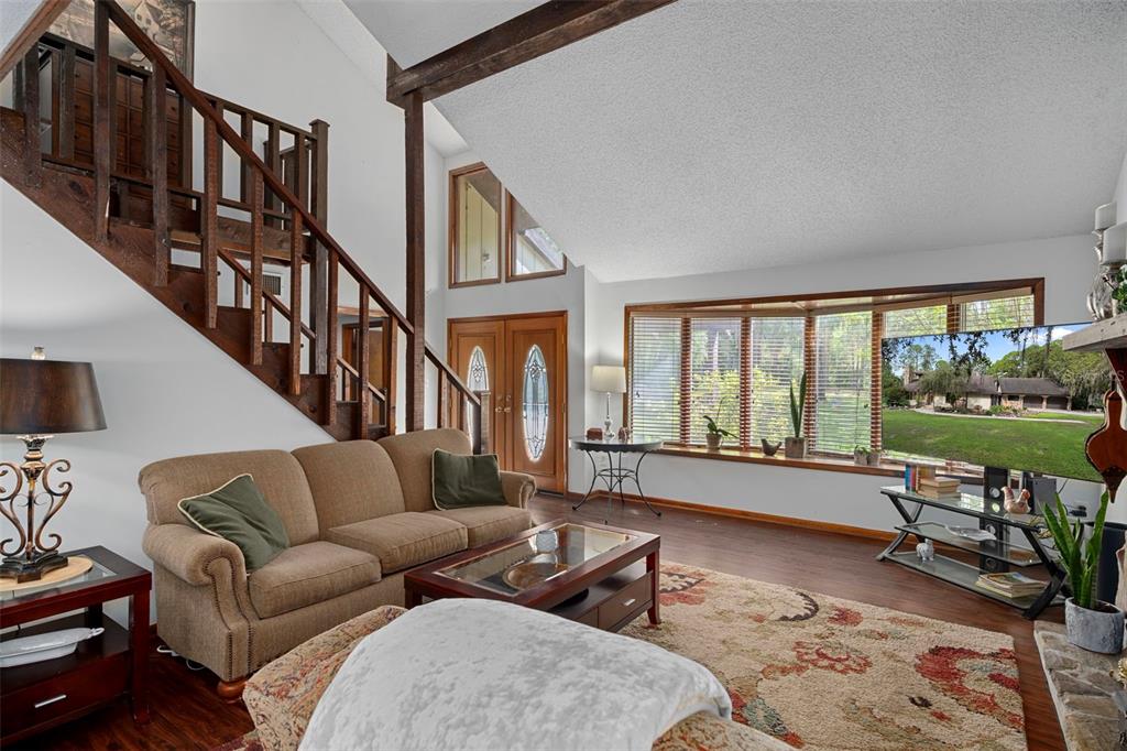 8605 Fussell Drive Wesley Chapel, FL 33545 - Photo 20 of 99 a living room with furniture and a floor to ceiling window