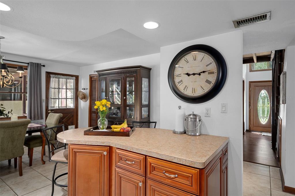8605 Fussell Drive Wesley Chapel, FL 33545 - Photo 30 of 99 a kitchen with a refrigerator a clock on the wall and a clock on the wall