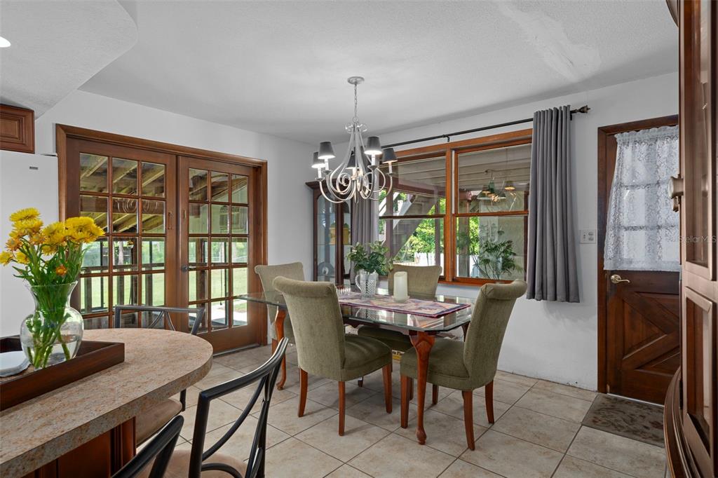 8605 Fussell Drive Wesley Chapel, FL 33545 - Photo 33 of 99 a dining room with furniture a chandelier and wooden floor