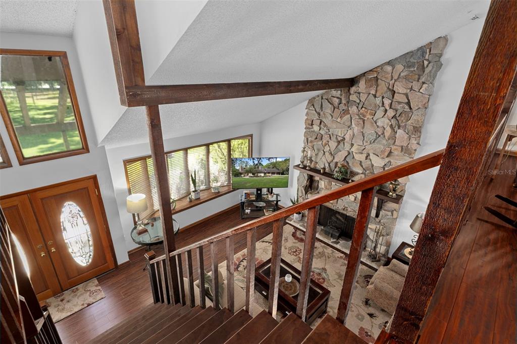 8605 Fussell Drive Wesley Chapel, FL 33545 - Photo 43 of 99 a view of an entryway with wooden floor and stairs