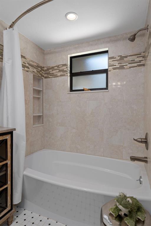 8605 Fussell Drive Wesley Chapel, FL 33545 - Photo 56 of 99 a bathroom with a bathtub and a shower