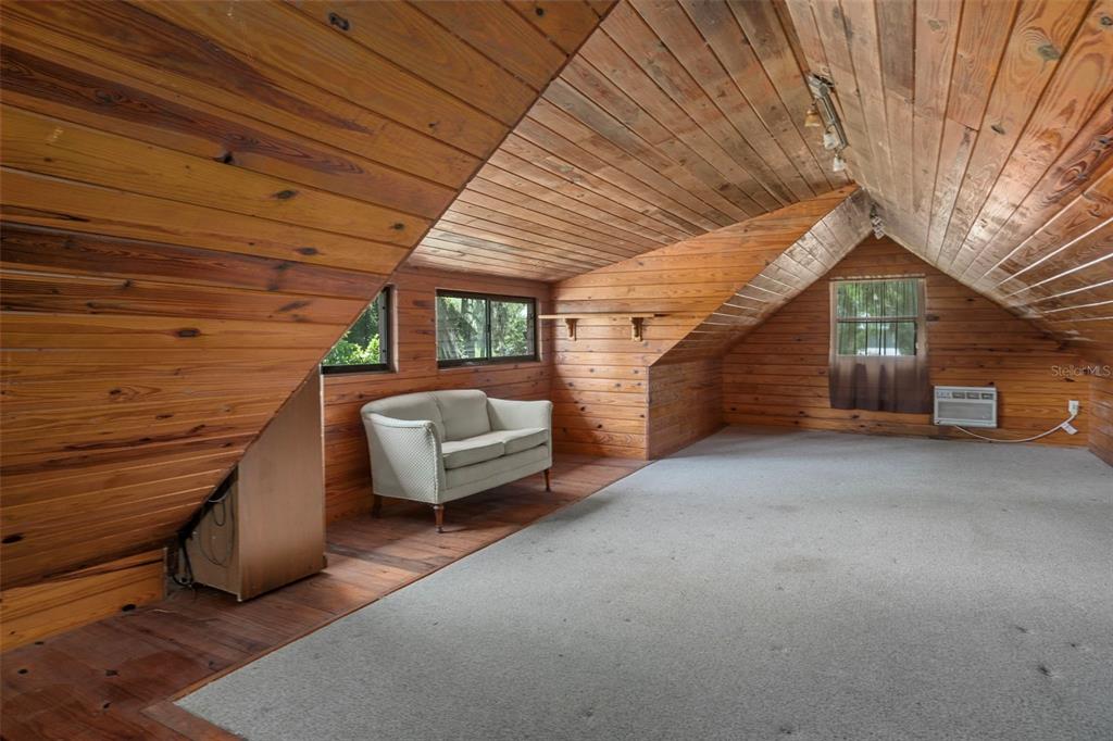 8605 Fussell Drive Wesley Chapel, FL 33545 - Photo 63 of 99 a view of a patio with table and chairs with wooden floor and fence