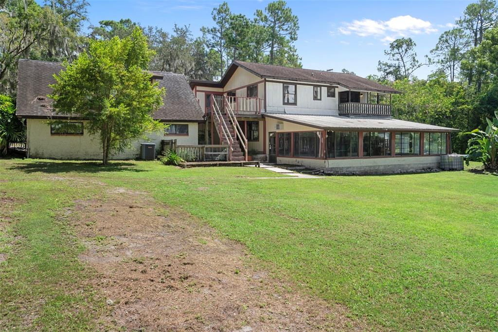8605 Fussell Drive Wesley Chapel, FL 33545 - Photo 75 of 99 a view of a house with a yard and sitting area