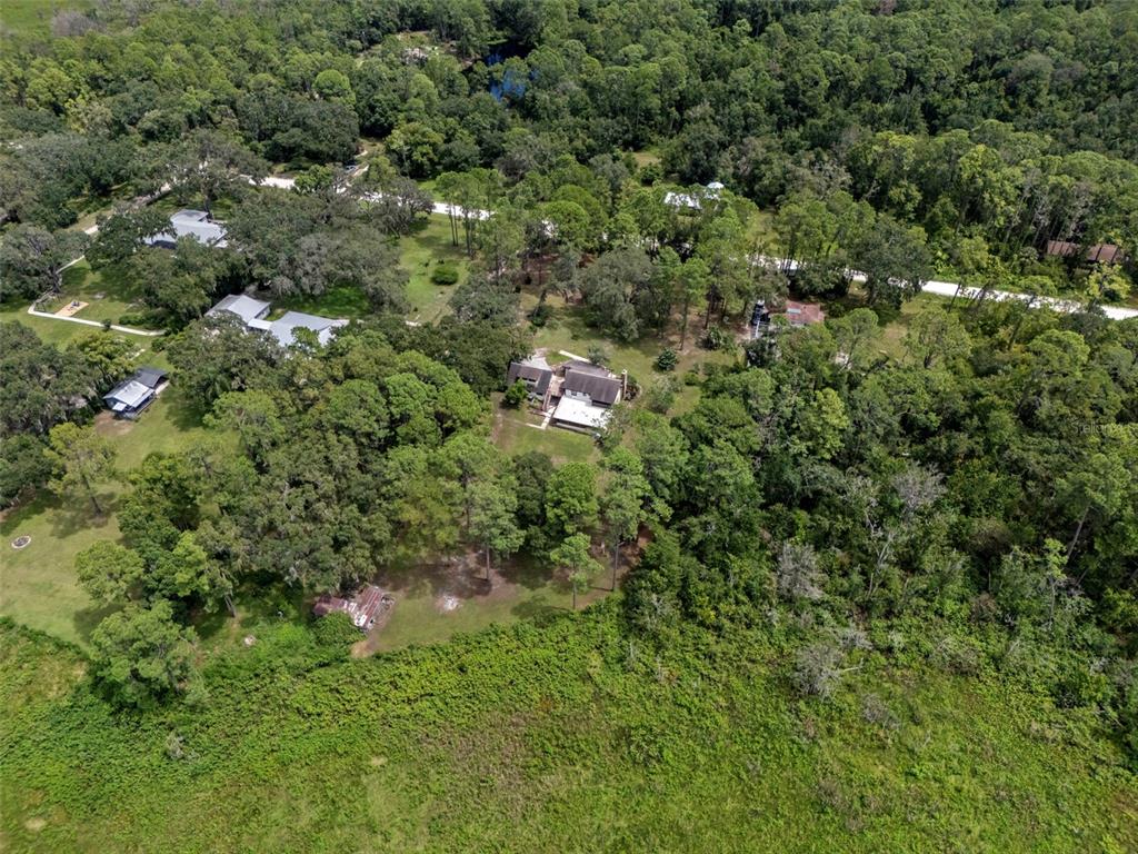 8605 Fussell Drive Wesley Chapel, FL 33545 - Photo 9 of 99 an aerial view of residential house with outdoor space and trees all around