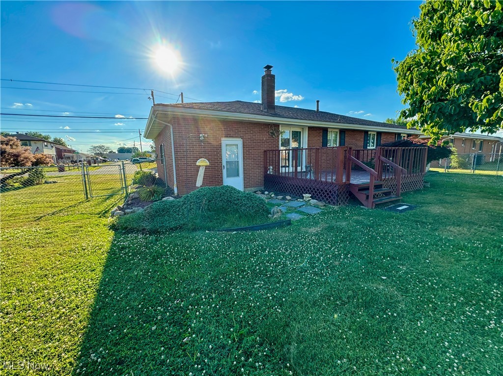 304 Stone Road Belpre, OH 45714 - Photo 31 of 34 Rear view of house with a lawn and a deck