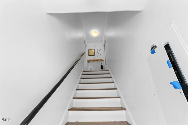 a view of a kitchen with wooden floor a ceiling fan and windows