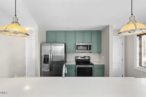 a kitchen with a stove microwave and refrigerator