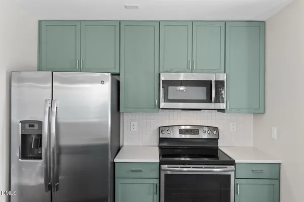a kitchen with a refrigerator sink and microwave