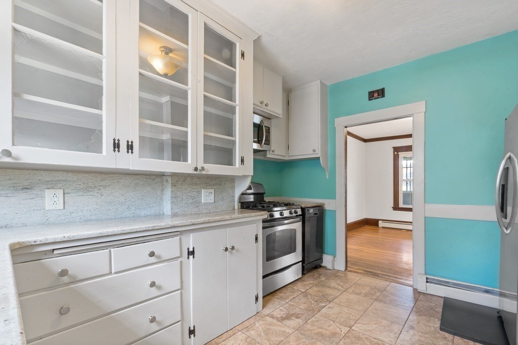 34 Harding Street Fall River, MA 02720 - Photo 11 of 32 a kitchen with stainless steel appliances granite countertop a stove and a cabinets