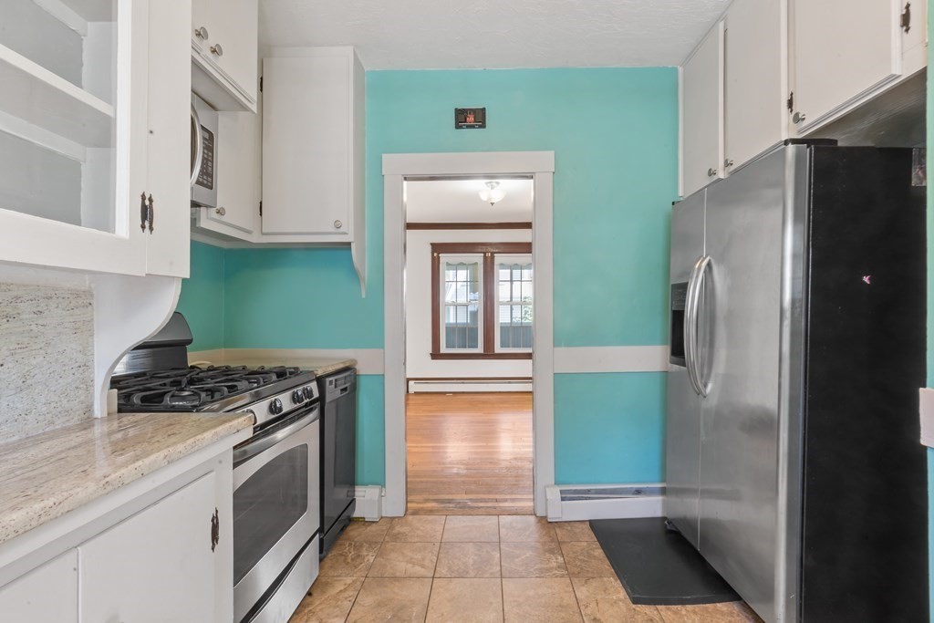 34 Harding Street Fall River, MA 02720 - Photo 12 of 32 a kitchen with a refrigerator and a stove