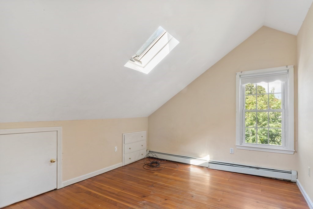 34 Harding Street Fall River, MA 02720 - Photo 27 of 32 an empty room with wooden floor chandelier fan and windows