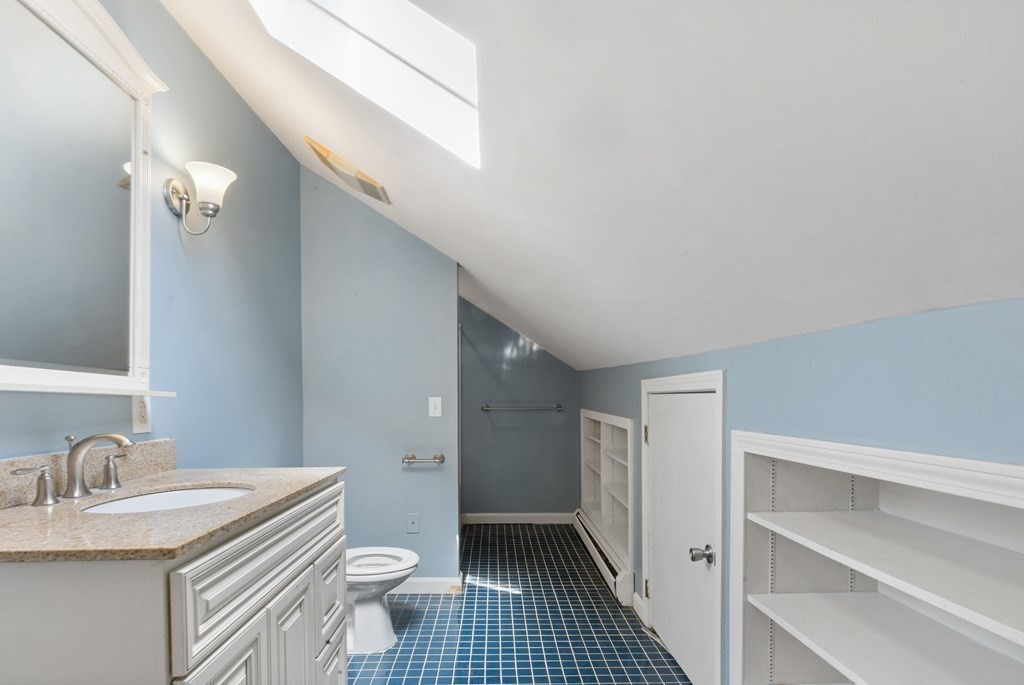 34 Harding Street Fall River, MA 02720 - Photo 31 of 32 a bathroom with a sink a toilet and a mirror