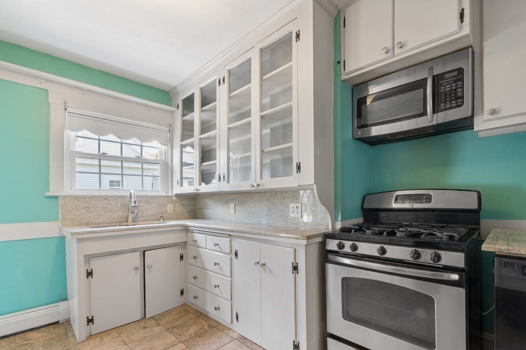 34 Harding Street Fall River, MA 02720 - Photo 9 of 32 a kitchen with cabinets appliances and a sink