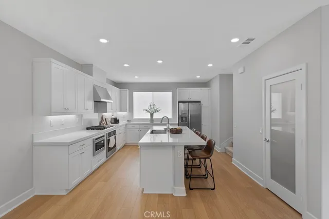 a kitchen with a white stove top oven and white cabinets