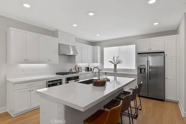 a kitchen with white cabinets