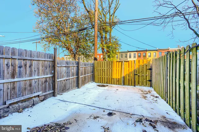 a view of a house with a wooden fence