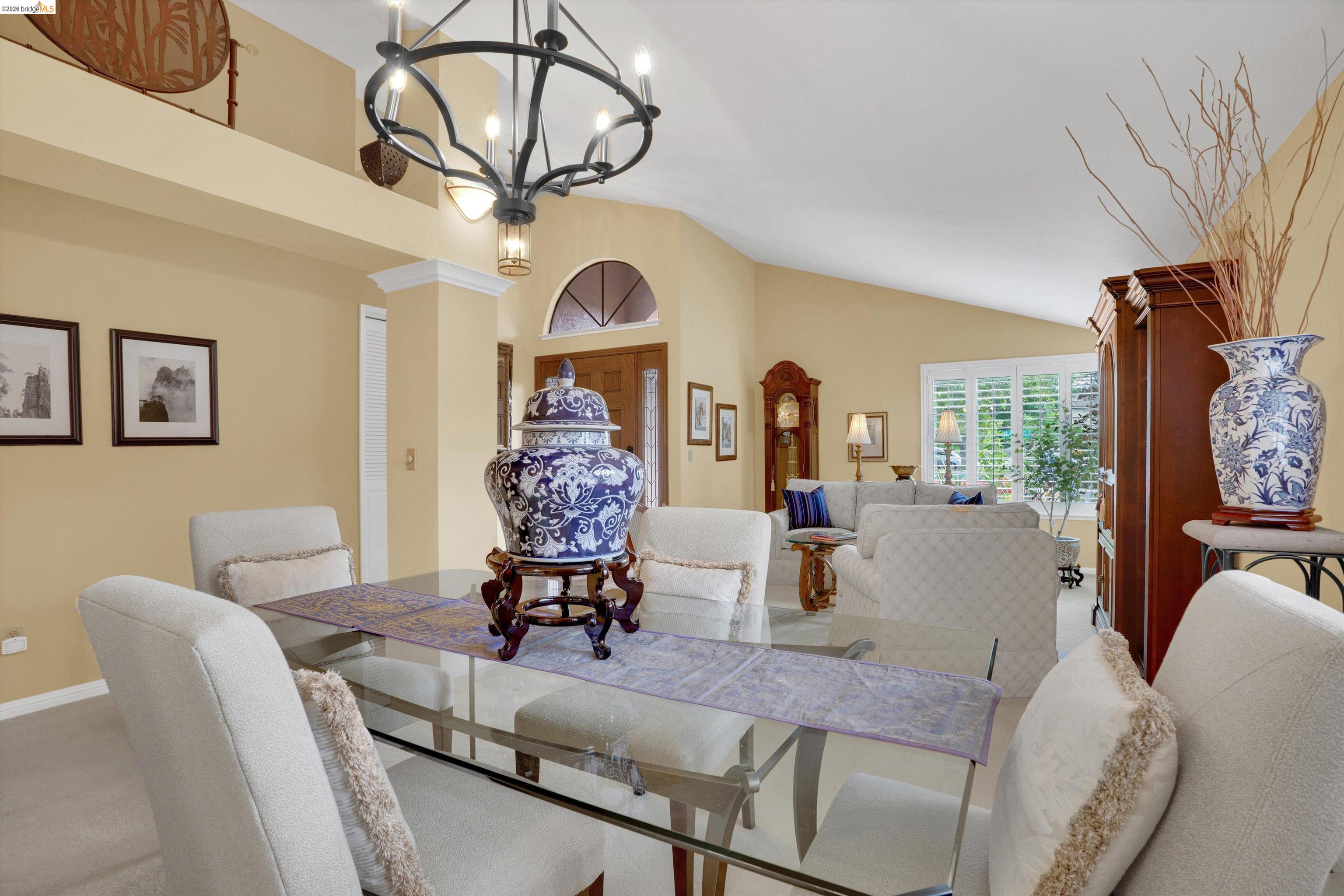 5001 St Garrett Court Concord, CA 94521 - Photo 17 of 45 Dining area featuring a glass-top table, upholstered chairs, and a chandelier with candle-style lights